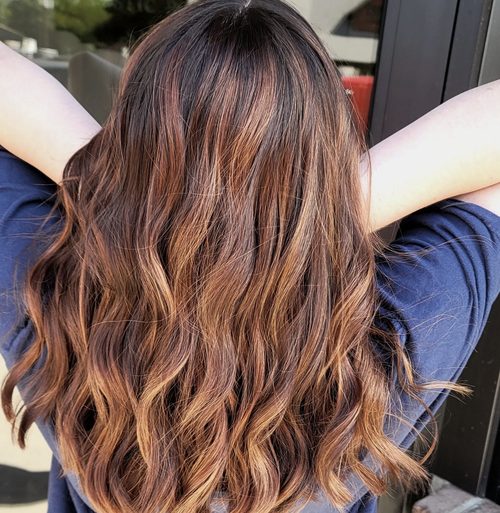 Auburn balayage melting through the mid-lengths
